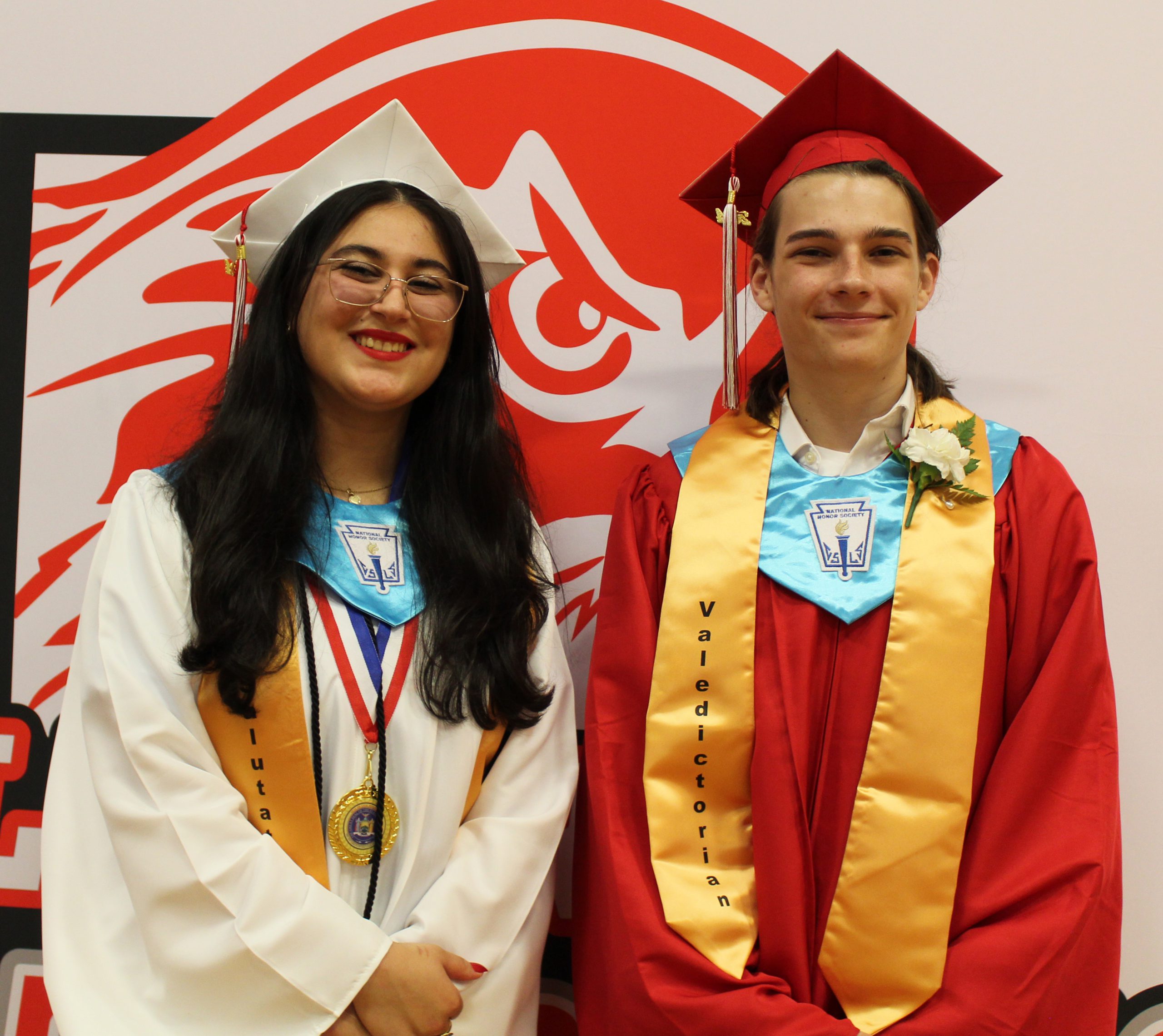 IMG_7451 The valedictorian and salutatorian pose for a photo in front of the liberty logo.