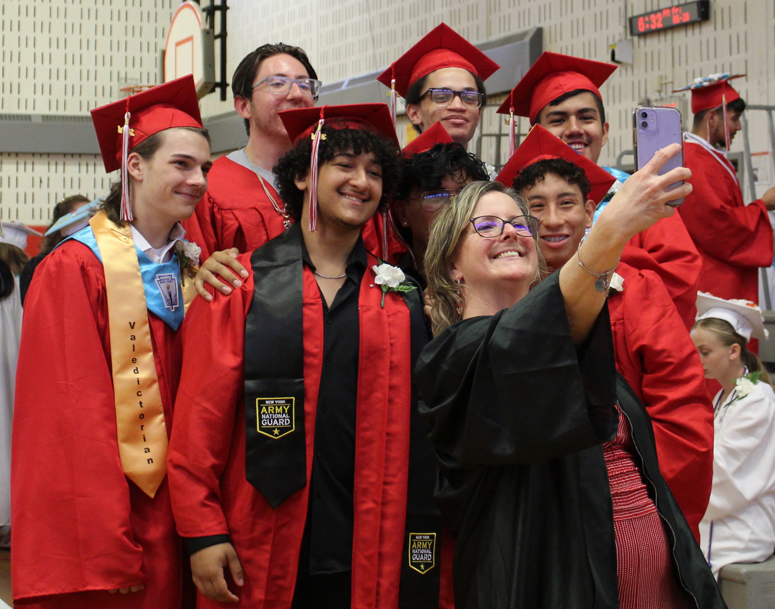 IMG_7472 An adult takes a selfie with a group of students.