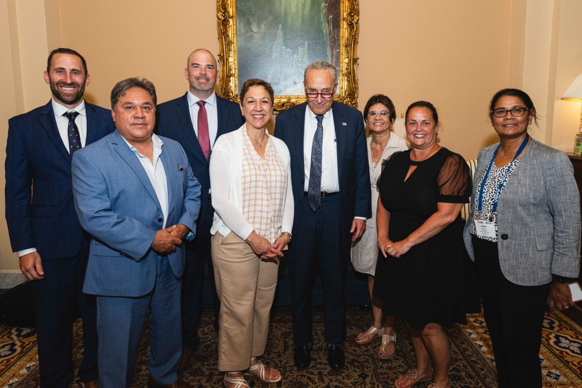 A group of eight people pose for a photo