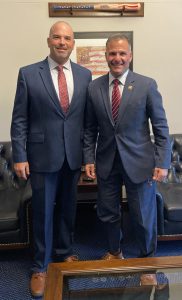 Two men pose for a photo