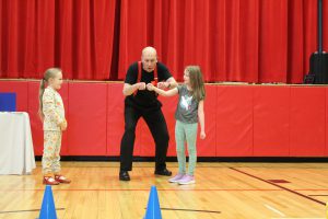 A magician does a trick with two students