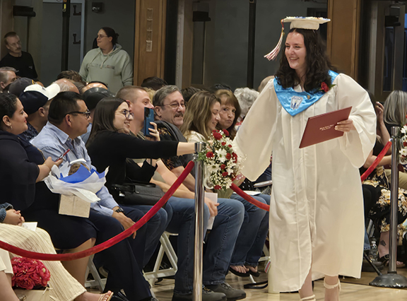 graduation30 a graduates shakes hand with an audience member