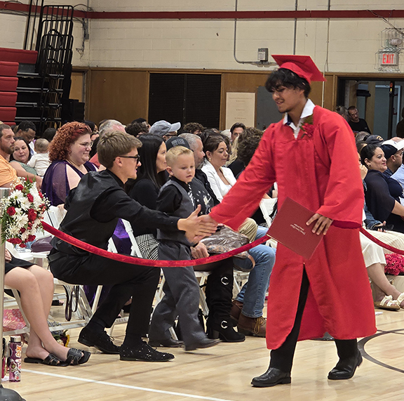 graduation29 A graduate shakes hands with an audience member