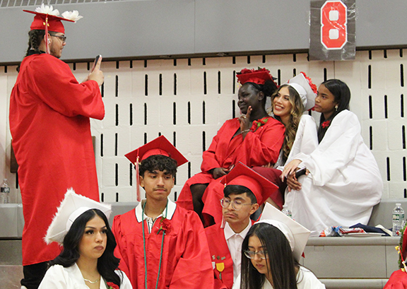 graduation23 A graduate takes a picture of three others.