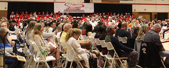 graduation15 Graduates sit on stands as the audience watches