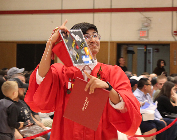 graduation8 A student points to his cap and looks up
