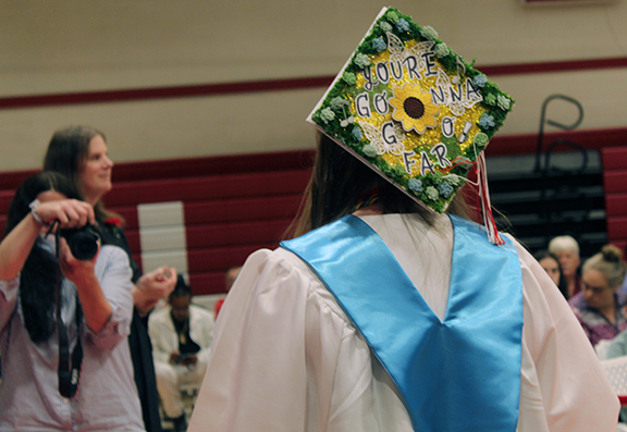 graduation 4 A person takes a picture of a graduate with a decorated cap