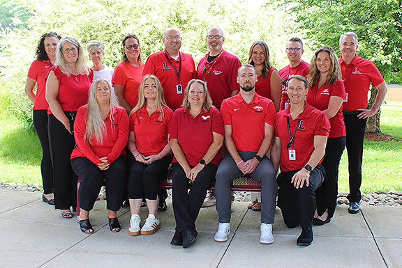 Members of the Liberty administration team pose for a photo outside.
