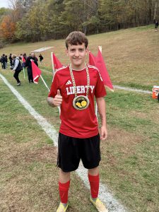A soccer player gives a thumbs
