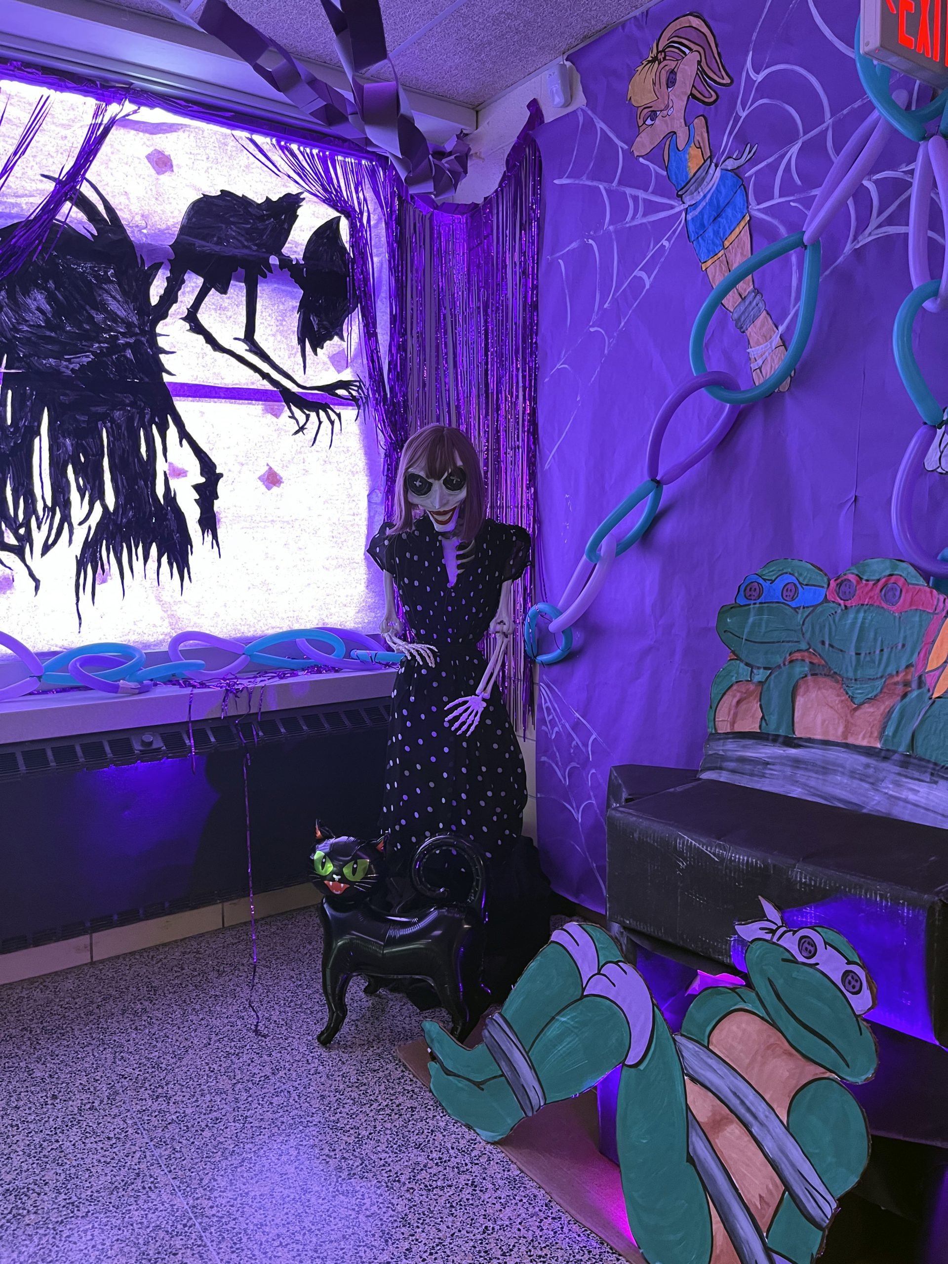 A hallway is decorated in a Coraline theme using characters from other class themes