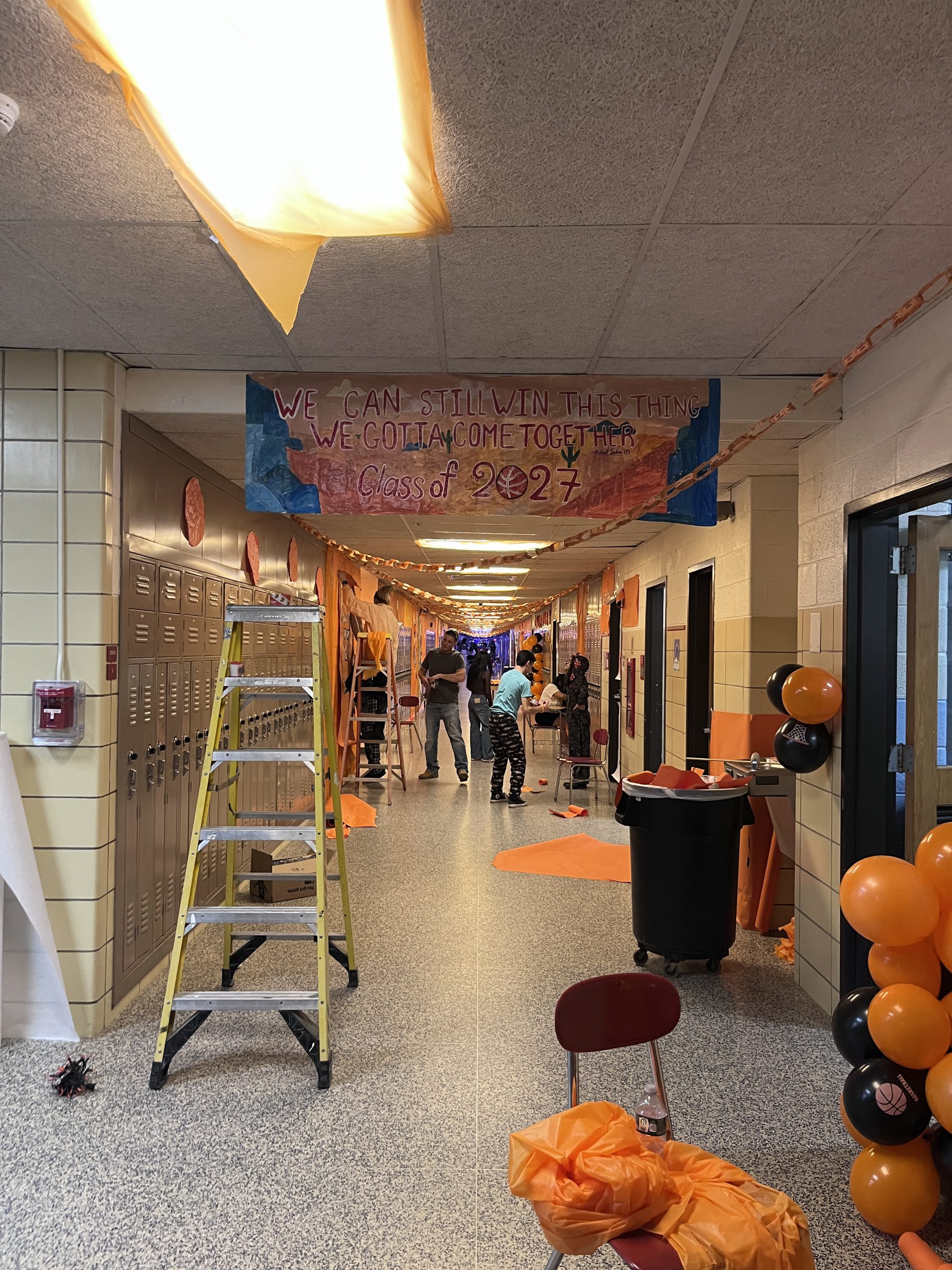 Students decorate a hallway in a Space Jam theme