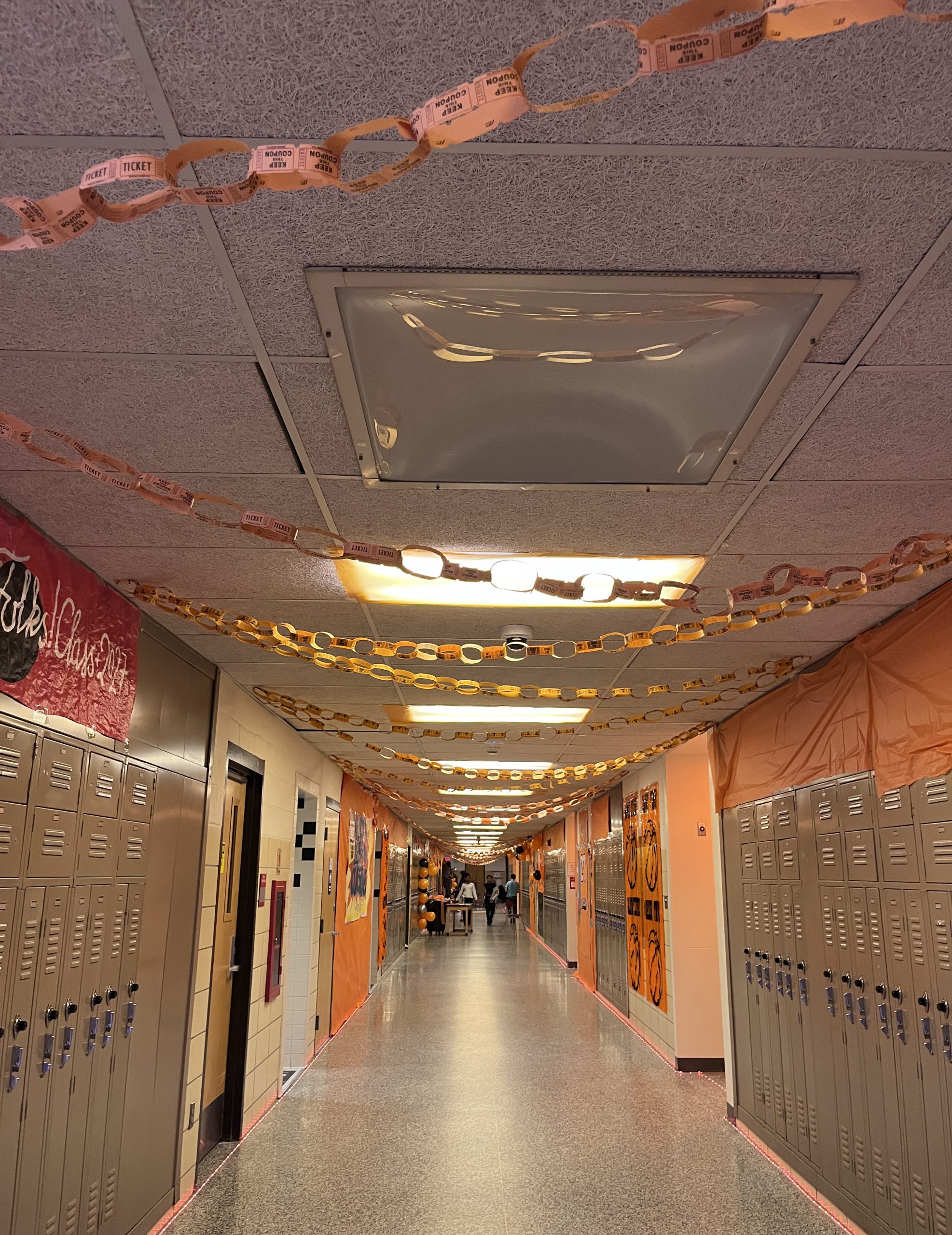 A hallway is decorated in orange in a Space Jam theme.
