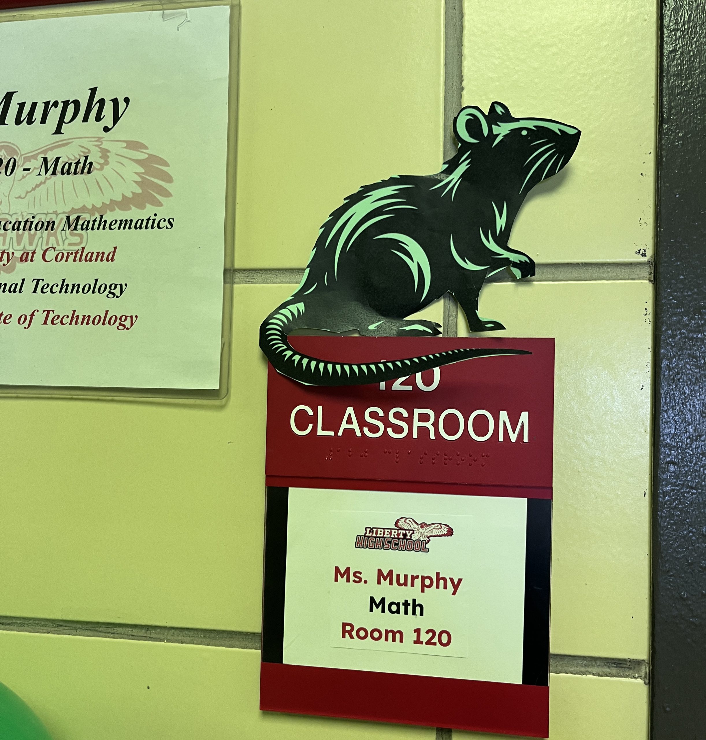 a drawing of a rat is placed above Mrs. Murphy's door placard.