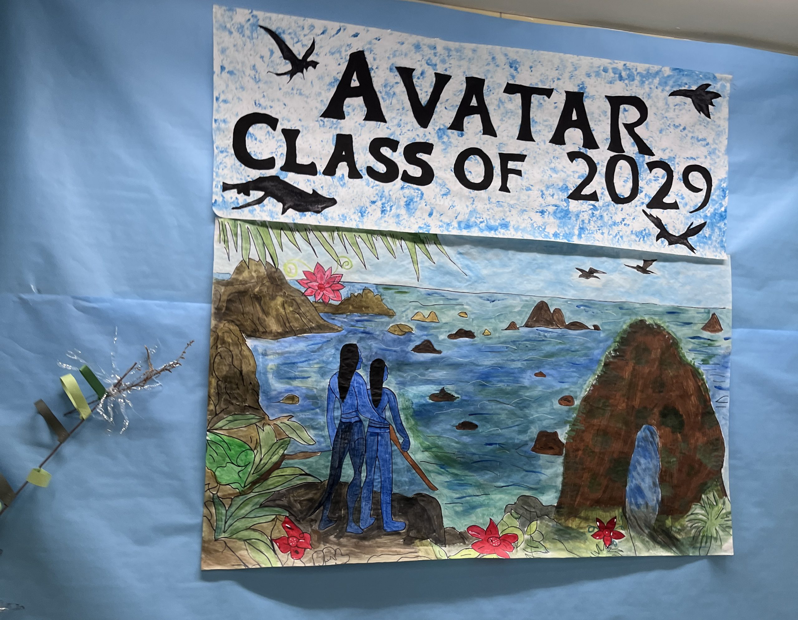 A scene from avatar is pained on a board with Avatar Class of 2029 written above it.