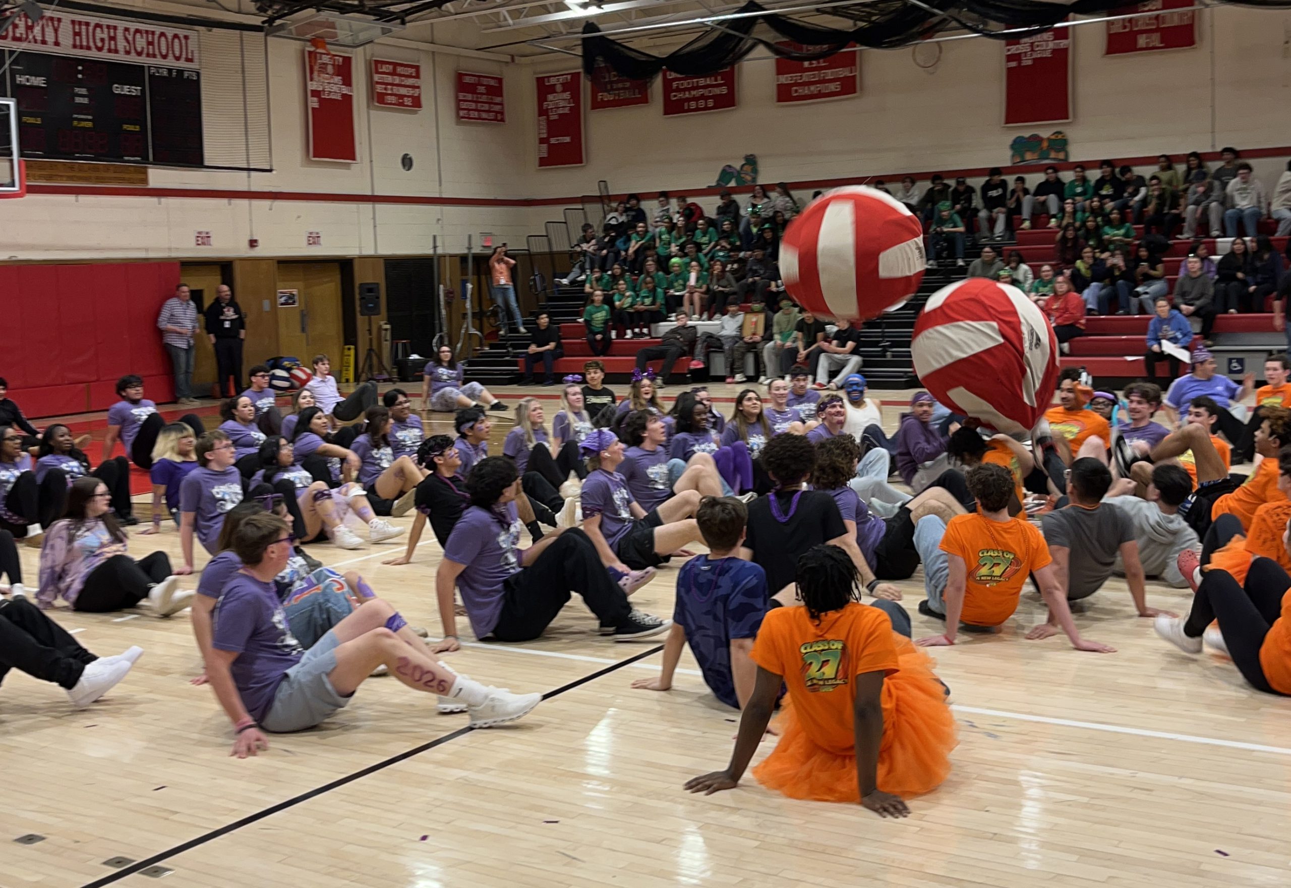 Students in orange and blue play crab soccer