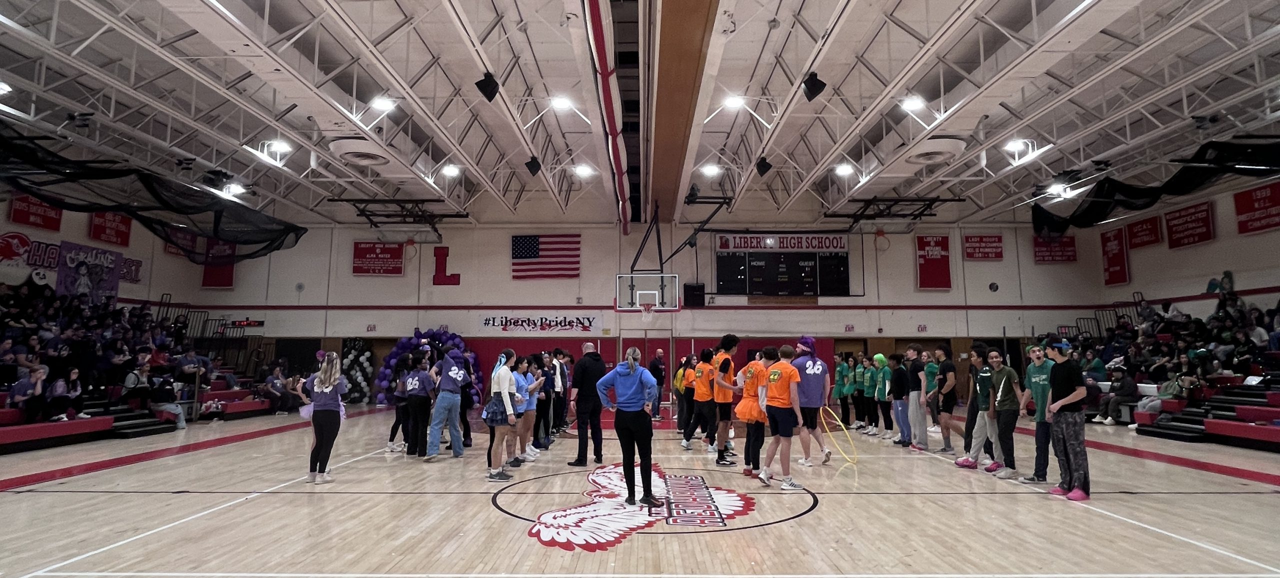 Students line up in the gym to play a game